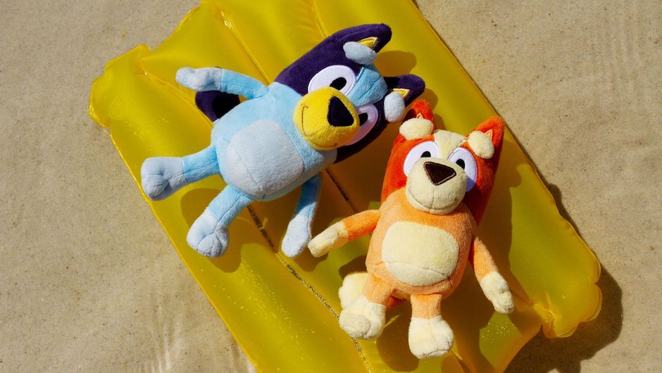 Bluey and Bingo laying on an inflatable