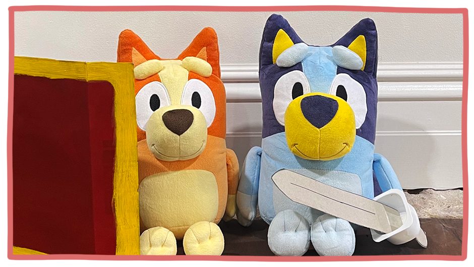 Lifestyle image of the Bingo and Bluey plush toys holding the DIY shield and sword.