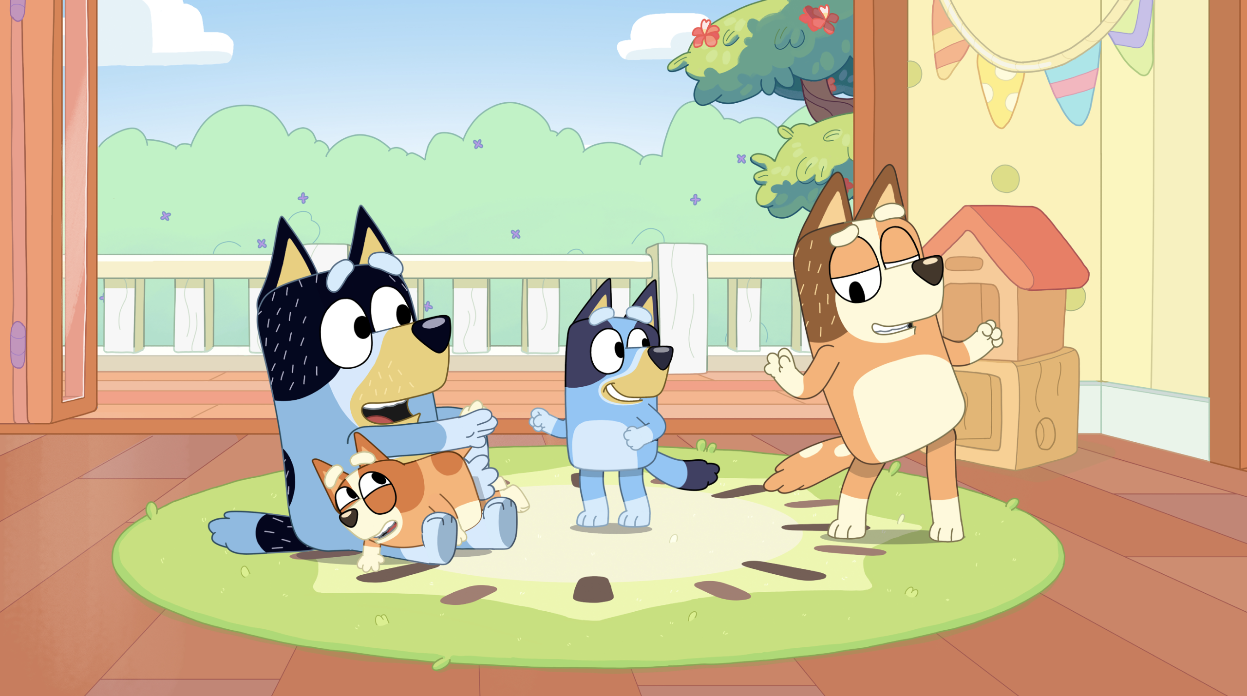 Bluey, Mum, Dad and Bingo dance in the playroom together.