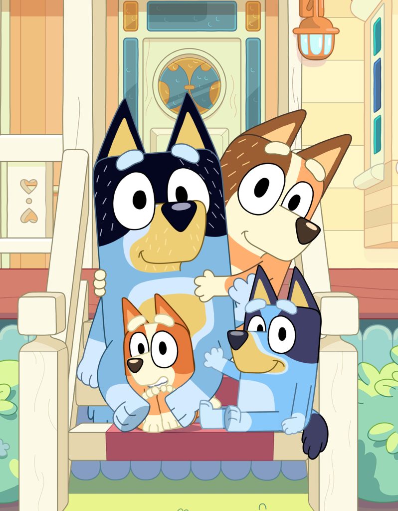 Bluey and her family sit together on a porch in front of their home, smiling in a relaxed setting